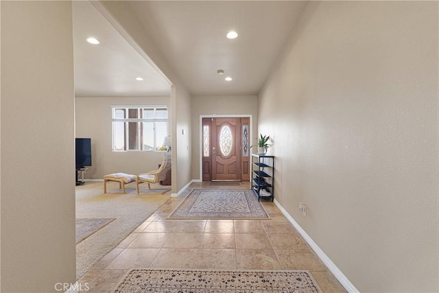 foyer featuring light colored carpet