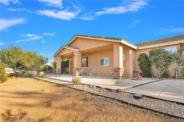 rear view of property featuring a patio