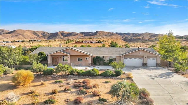 single story home with a garage and a mountain view