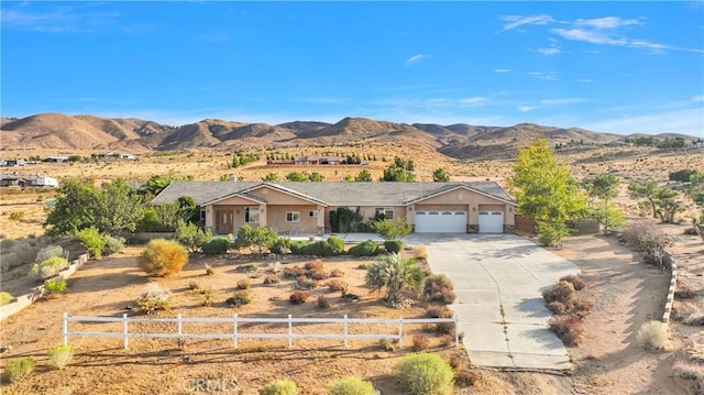 single story home with a garage and a mountain view