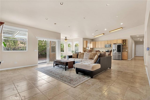 living room with ceiling fan and vaulted ceiling