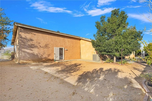 back of house featuring central AC and a patio area