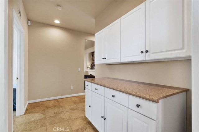 kitchen featuring white cabinets