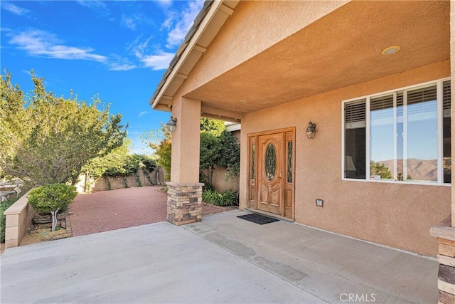 entrance to property featuring a patio