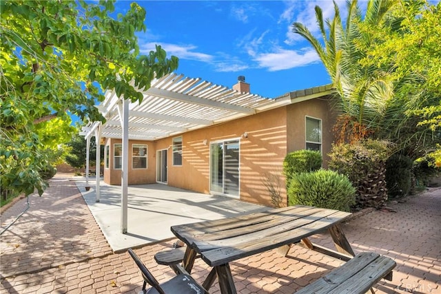 rear view of house with a patio and a pergola