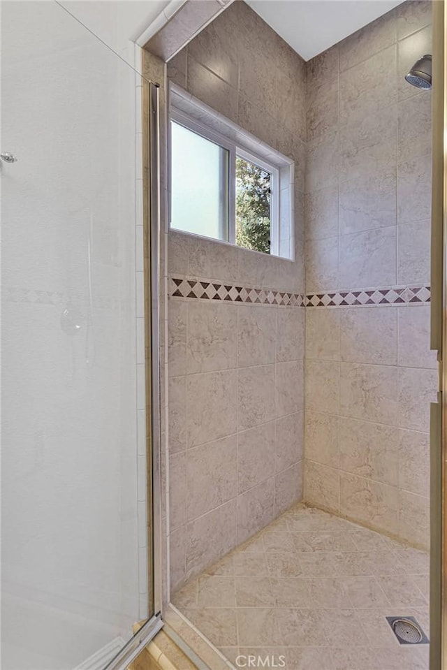 bathroom with a shower with door