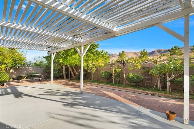 view of patio with a pergola and a mountain view