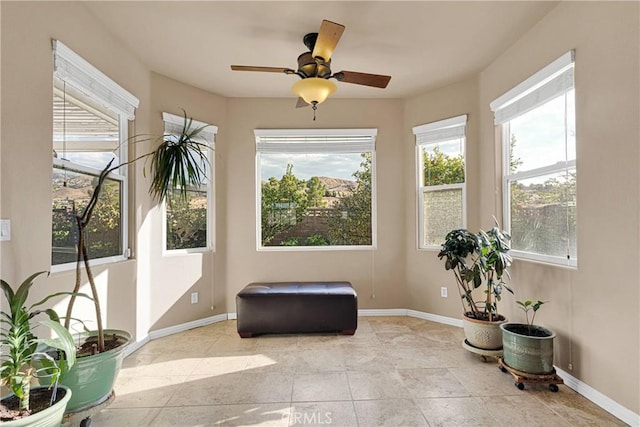 sunroom / solarium featuring ceiling fan