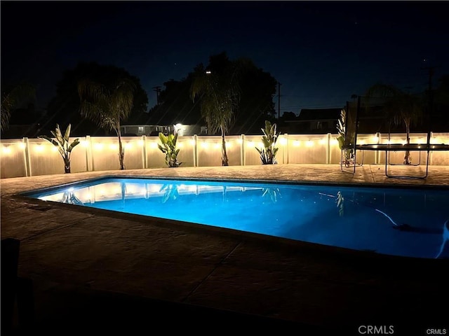 view of pool at night