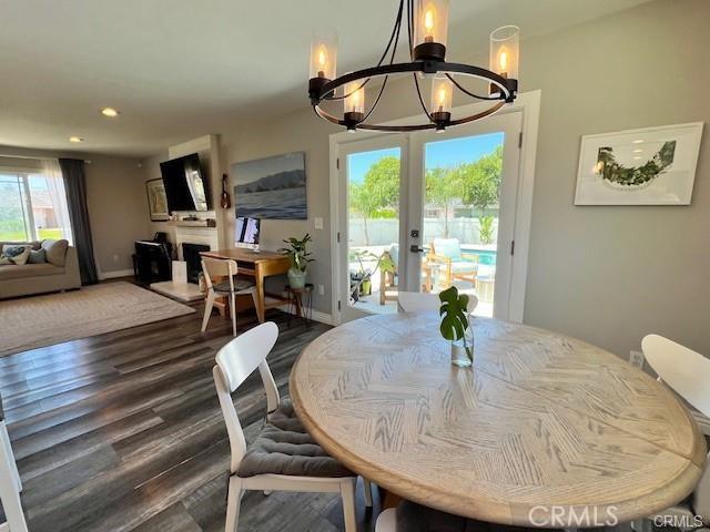 dining area featuring french doors, dark hardwood / wood-style flooring, and a chandelier