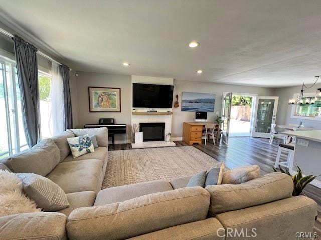 living room featuring dark hardwood / wood-style floors and a notable chandelier