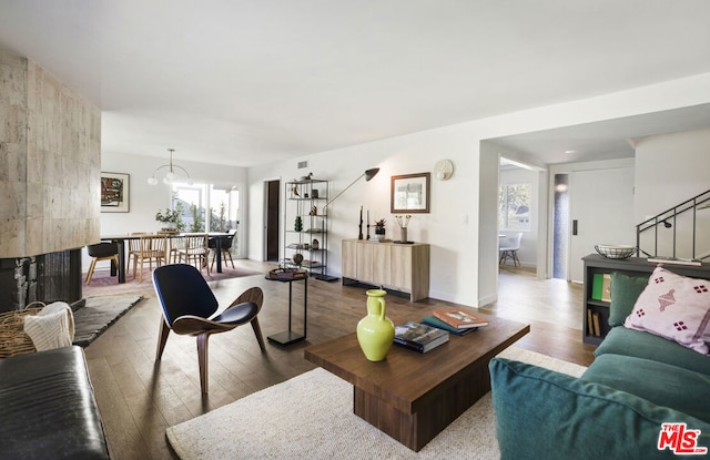 living room featuring wood-type flooring and a chandelier