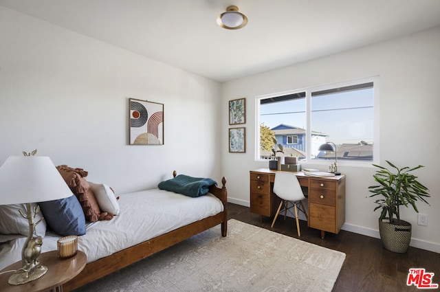 bedroom featuring dark hardwood / wood-style flooring