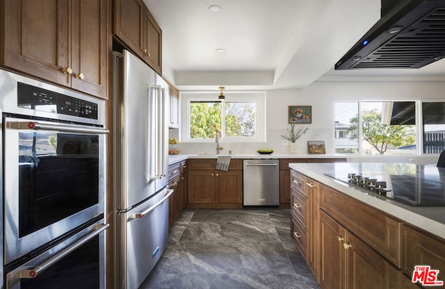 kitchen featuring a wealth of natural light, appliances with stainless steel finishes, extractor fan, and sink