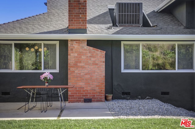 rear view of house with a patio area and cooling unit