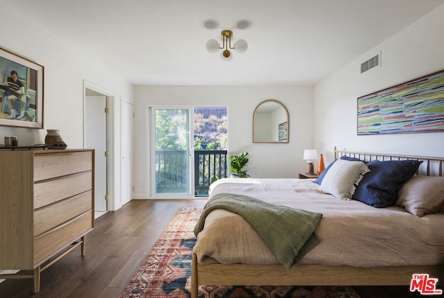 bedroom with access to exterior and dark hardwood / wood-style floors