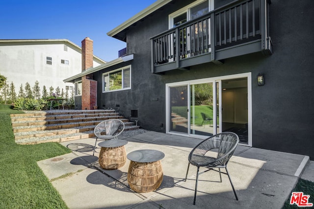 view of patio featuring a balcony