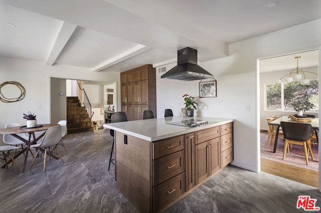 kitchen with a breakfast bar, wall chimney exhaust hood, and black electric stovetop