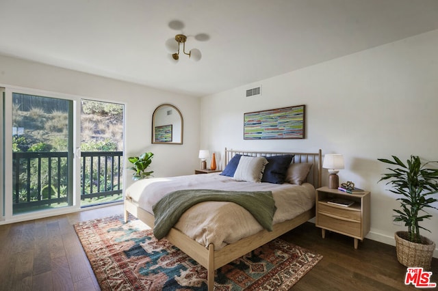 bedroom with dark hardwood / wood-style floors and access to outside