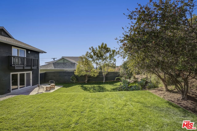 view of yard featuring a patio area and a balcony