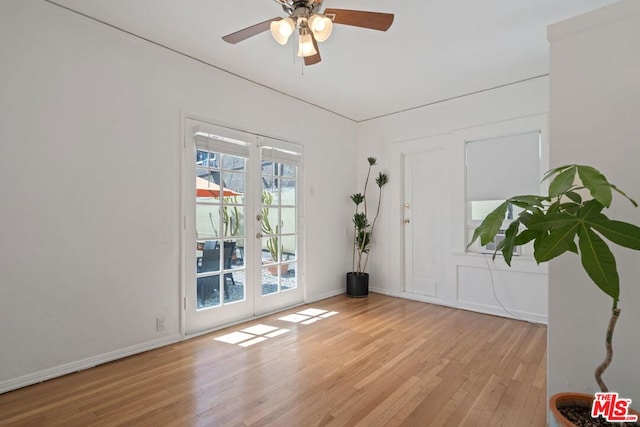 spare room featuring ceiling fan, french doors, and light hardwood / wood-style flooring