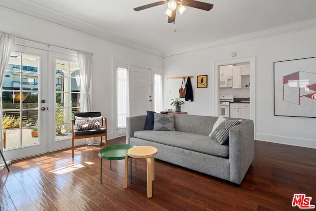 living room with ceiling fan, dark hardwood / wood-style flooring, ornamental molding, and french doors