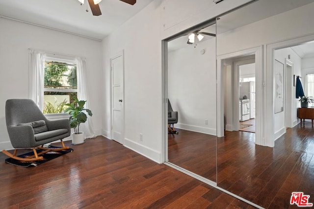 sitting room with ceiling fan and dark hardwood / wood-style floors