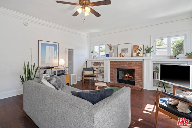 living room featuring a brick fireplace, a wealth of natural light, dark hardwood / wood-style floors, and ceiling fan