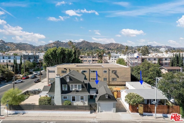 birds eye view of property featuring a mountain view