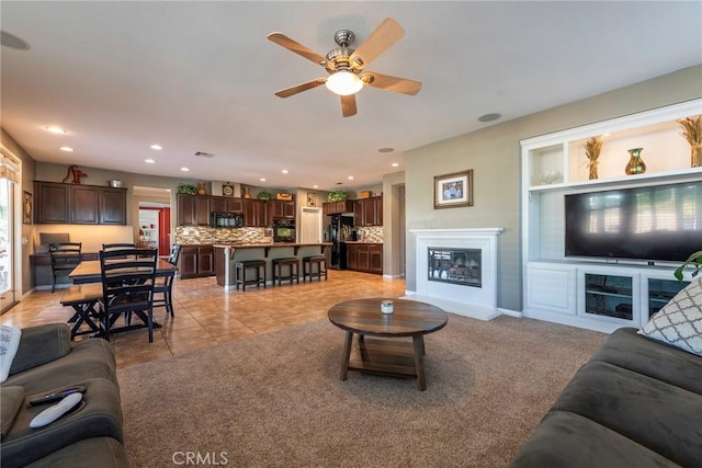 tiled living room featuring ceiling fan