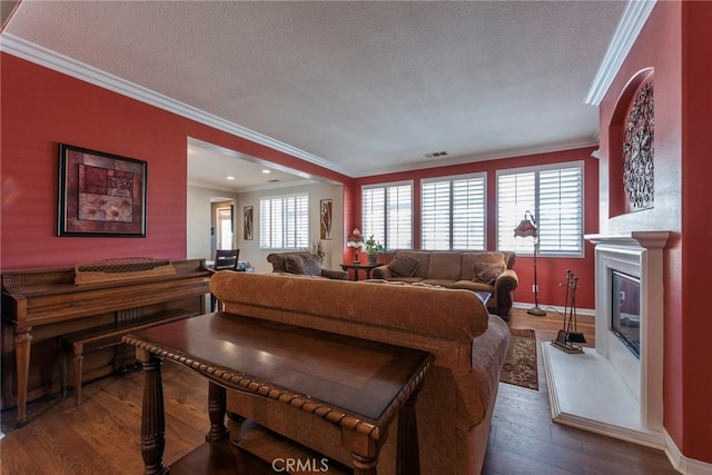 living room featuring hardwood / wood-style flooring and crown molding