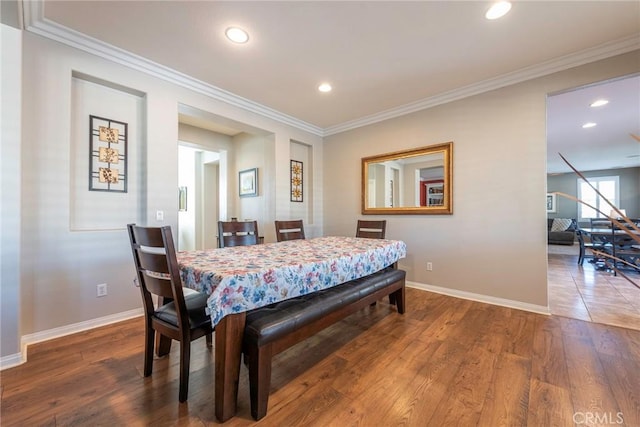 dining room with hardwood / wood-style floors and ornamental molding