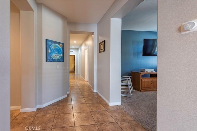 hall featuring light tile patterned floors