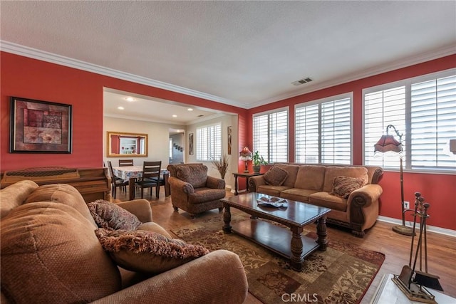 living room with crown molding and light hardwood / wood-style flooring