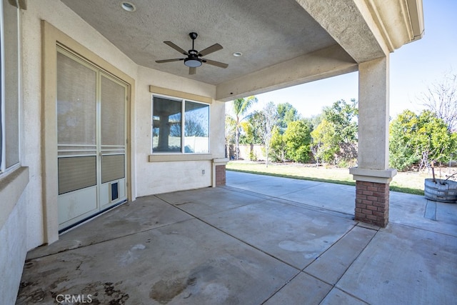 view of patio / terrace with ceiling fan and fence