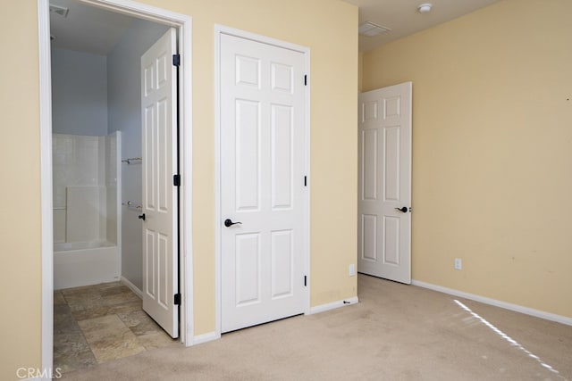 corridor featuring carpet, visible vents, and baseboards