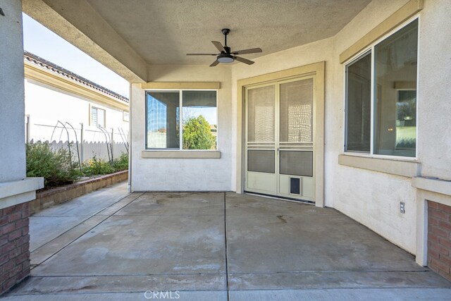 view of patio featuring fence and a ceiling fan