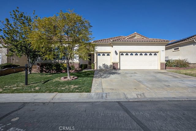 view of front of house with an attached garage, concrete driveway, a tiled roof, stucco siding, and a front lawn