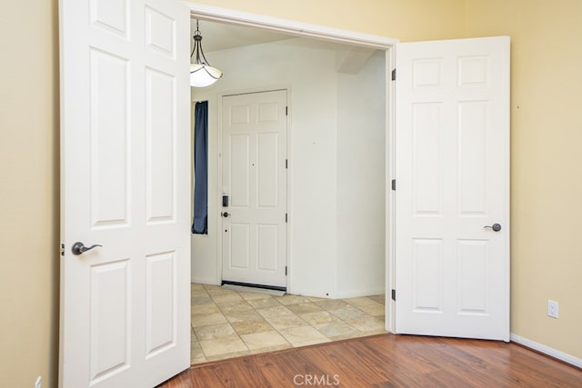 interior space featuring light wood-style flooring and baseboards