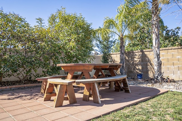 view of patio with outdoor dining space and a fenced backyard