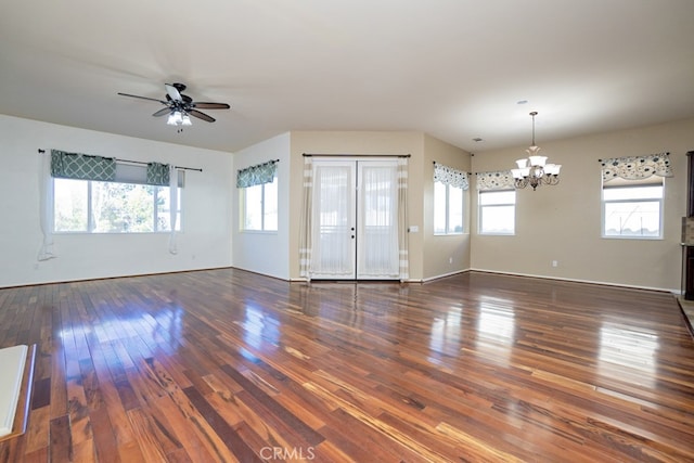 unfurnished living room featuring ceiling fan with notable chandelier and wood finished floors