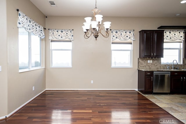 kitchen with dark brown cabinetry, tasteful backsplash, visible vents, dishwasher, and light wood-type flooring