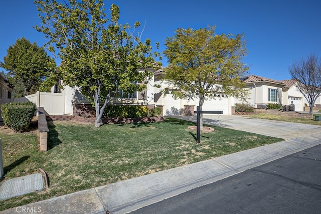 view of property hidden behind natural elements featuring a garage, concrete driveway, a tile roof, fence, and a front yard