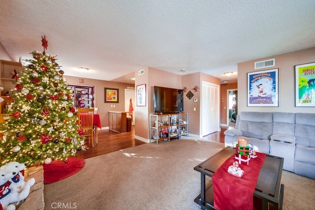 living room with carpet floors and a textured ceiling