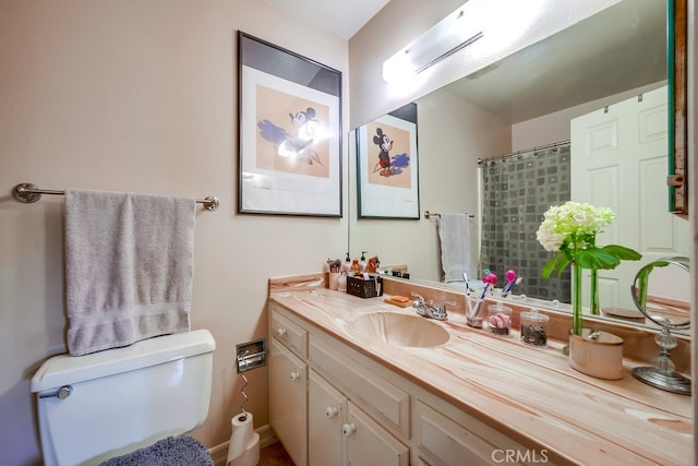 bathroom featuring toilet, walk in shower, and vanity