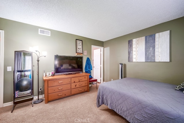 carpeted bedroom with a textured ceiling