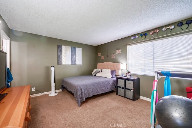 bedroom with light colored carpet and a textured ceiling