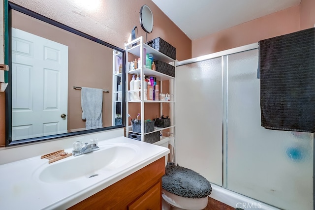 bathroom with vanity, toilet, and walk in shower