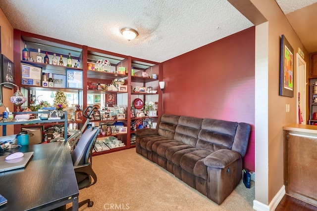 carpeted office space featuring a textured ceiling