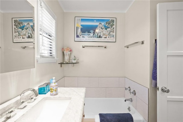 bathroom featuring a washtub and vanity